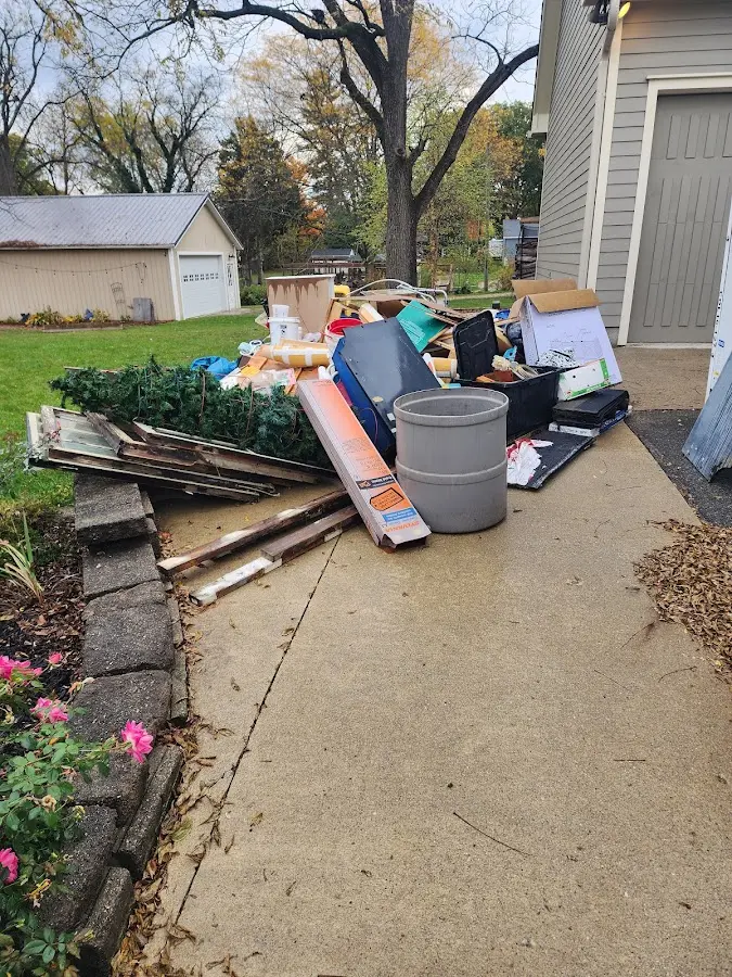 Dumpster being loaded with debris for Roofing Dumpster Rental in McMinnville